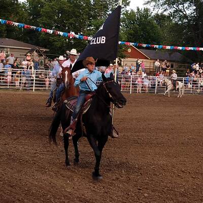 Colby Stoller carrying our Sabetha Saddle Club flag in the 65th annual NE KS rodeo July 2020