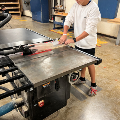 Sabetha student using the new joiner in shop class
