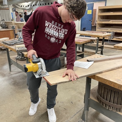 Sabetha student using new cordless circular hand saw.